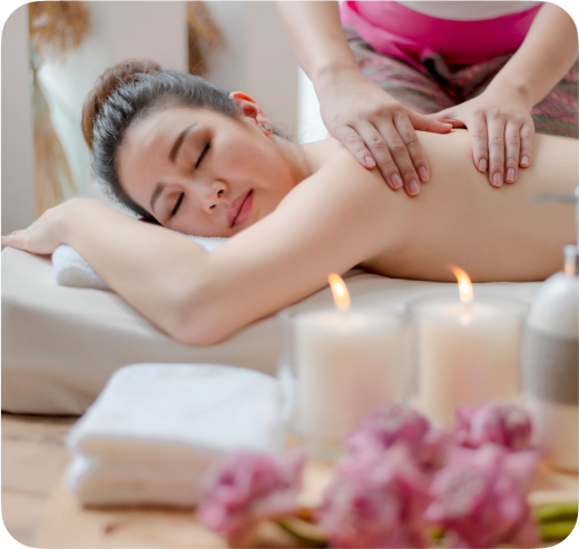 A woman of Asian descent undergoing a traditional Thai massage treatment