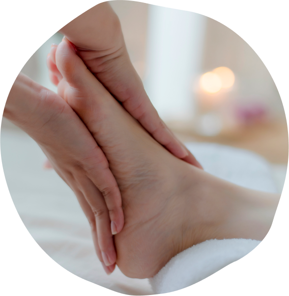Close-up of hands providing a soothing Thai foot massage London by massaging the soles of the feet and applying pressure to specific reflex points for relaxation and wellness.