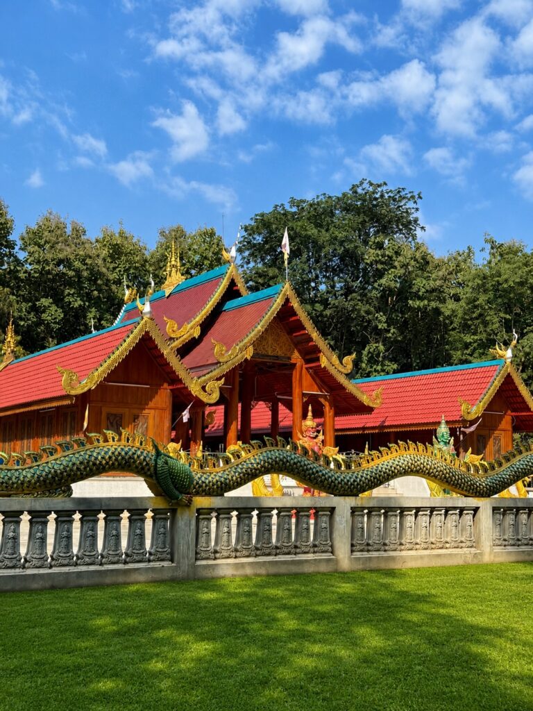 Traditional Thai temple with green dragon sculptures and ornate architecture in northern Thailand.