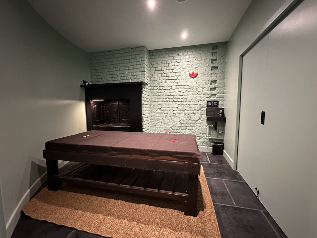 Therapy Room at Asiatic - Featuring a soothing green wall, spotlessly clean decor."
