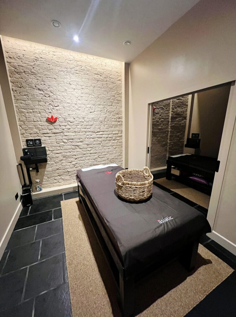 Asiatic massage room new branch opening - serene setting with traditional decor and soothing ambiance.