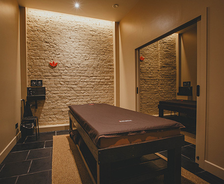 A tranquil therapy room in Islington, elegantly decorated with serene colors and inviting furnishings, offering a serene ambiance for relaxation and rejuvenation.