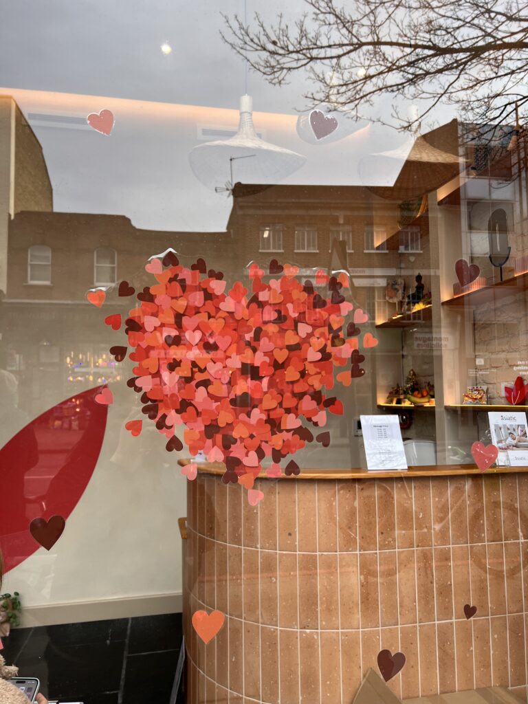 Heart-shaped outline on a window with the Asiatic London logo, symbolizing Valentine's Day romance at the massage spa.