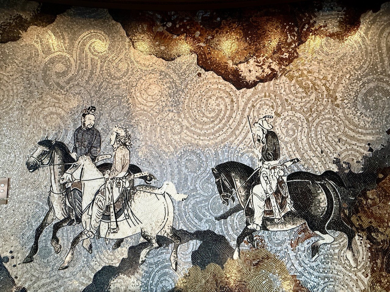 A 10-metre mosaic of three horsemen captured at the Shanghai Tower, representing the indestructible structural integrity and 17-year legacy of Asiatic Thai Massage in Angel, London.