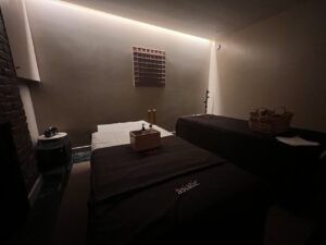 Best Couples massage London, at Asiatic Highbury in Islington featuring two treatment beds, warm lighting and a calm boutique wellness atmosphere.