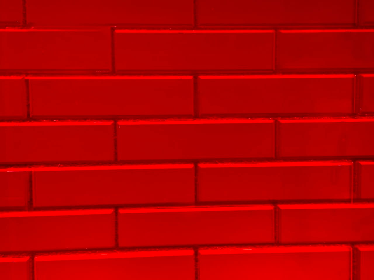 An architectural red brick wall integrated with translucent glass blocks, serving as a structural metaphor for breaking down stubborn muscle knots and restoring transparency at Asiatic Thai Massage in Islington, London