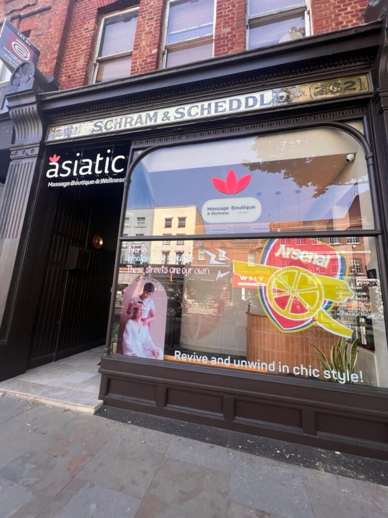 Asiatic Thai Massage Upper Street storefront with hand-drawn Arsenal cannon tribute for the Islington parade