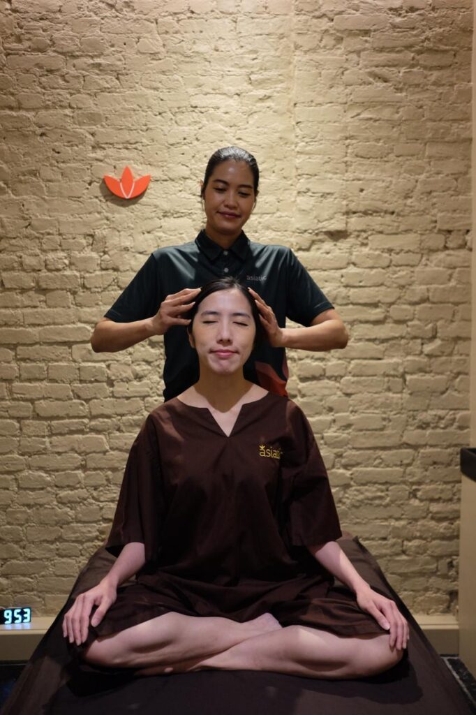 Therapist performing head massage and nervous system relaxation treatment at Asiatic Thai Massage in Islington, London.