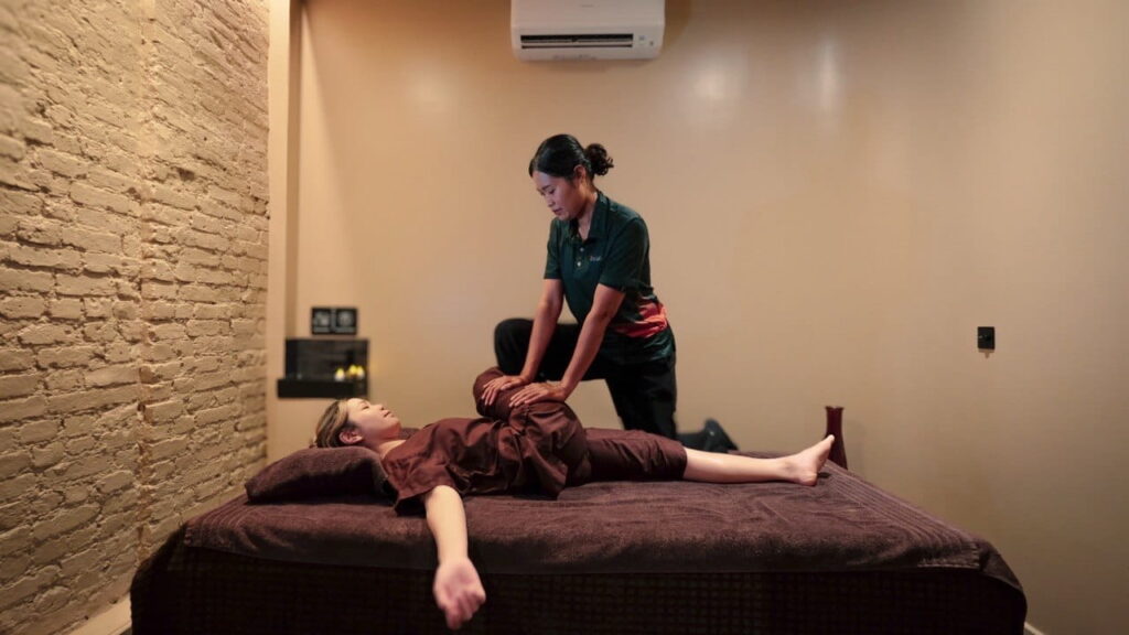Massage therapist performing Thai massage at Asiatic Thai Massage Angel. 