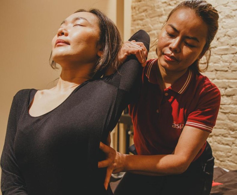 Therapist giving an assisted Thai stretch at Asiatic