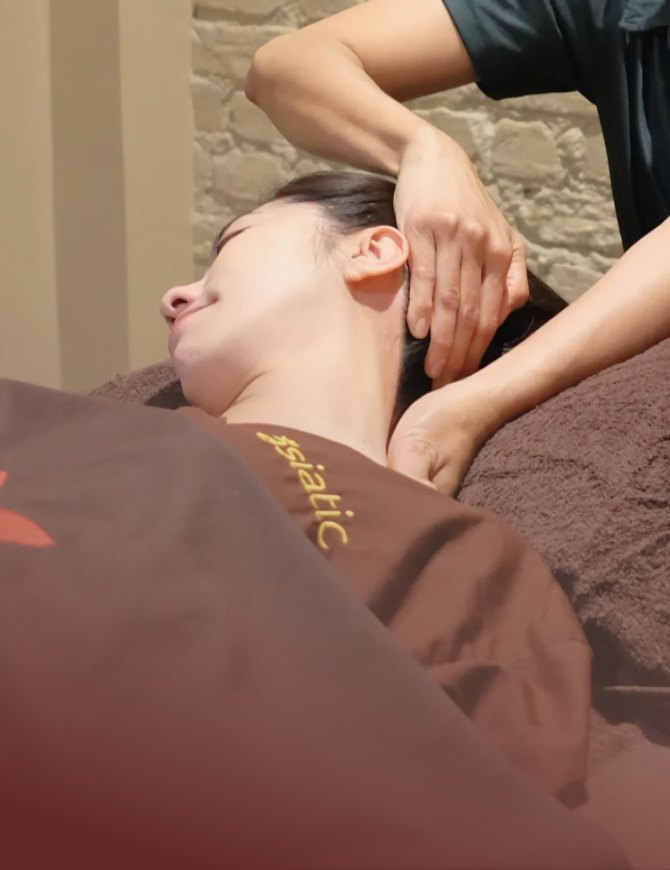 Head and neck massage in an Asiatic treatment room